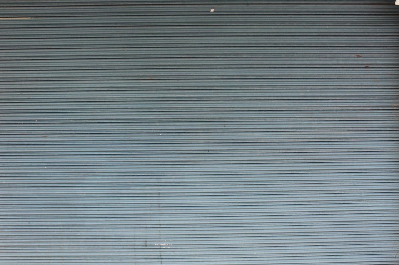 Industrial gray metal shutter door with horizontal lines creating a textured effect. Perfect for backgrounds.